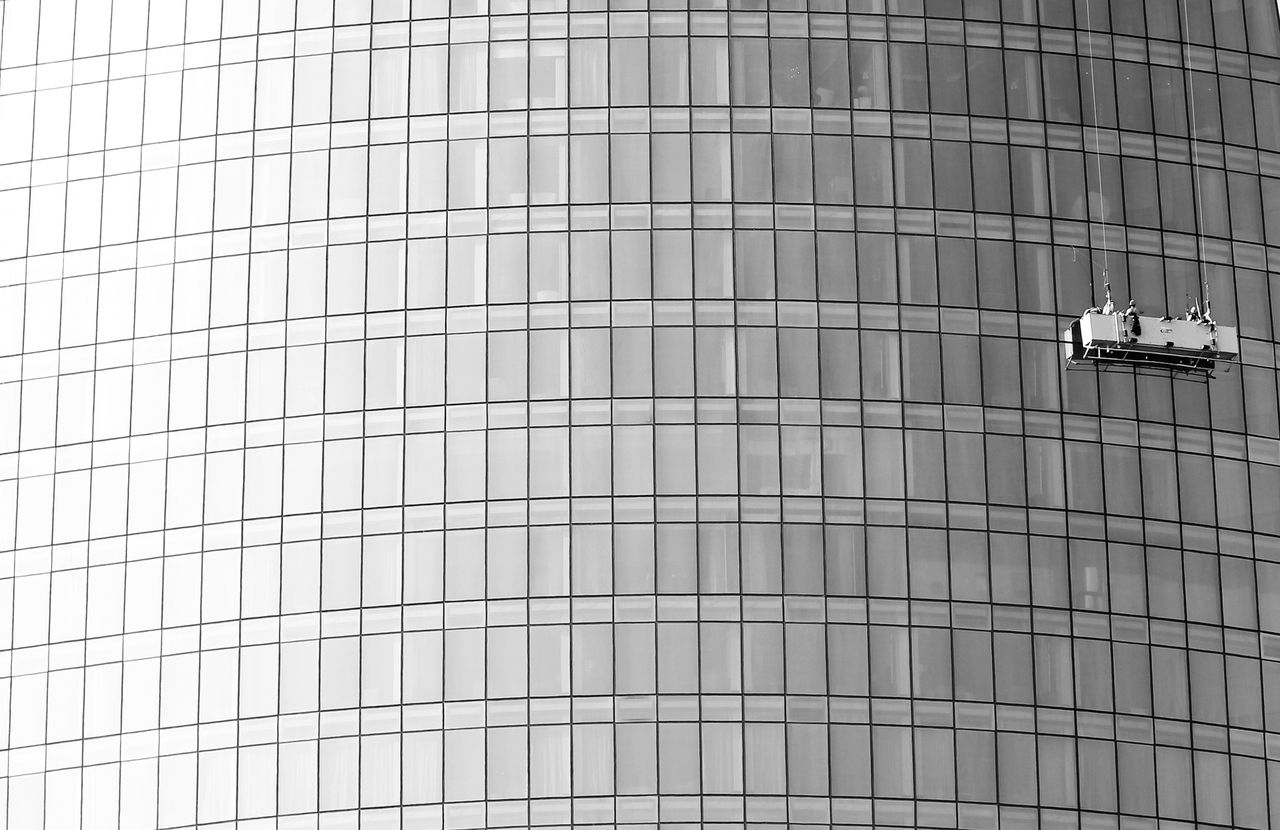 project-02-b High-rise glass facade with suspended platform for window cleaning.
